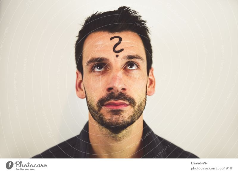 Man with question mark on forehead Meditative Question mark ? Think ponder Asking look Insecure thoughts Future