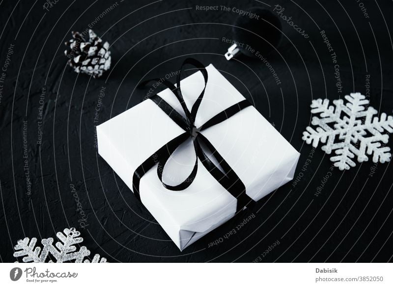 Christmas composition. Gift box with and christmas decorations on dark  background, top view - a Royalty Free Stock Photo from Photocase