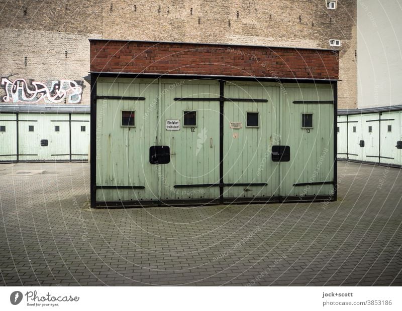 friendly multi-purpose garages Garage Multi-purpose garage GDR Architecture Prenzlauer Berg Fire wall Garage door Retro Ravages of time Smiley Closed