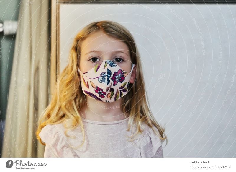 Blond Girl with Protective Face Mask child girl portrait mask protective face mask blond caucasian lifestyle female looking at camera indoor natural lighting
