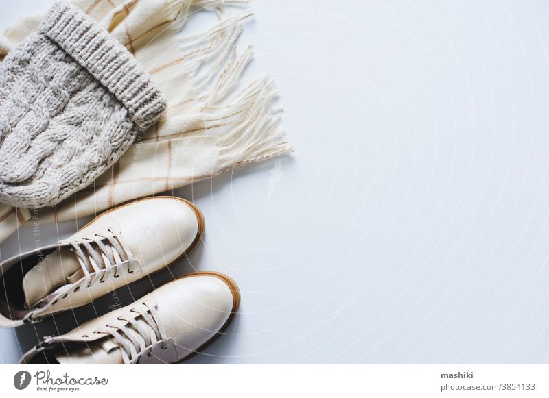 winter fashion set top view. Online shopping concept. Shoes, knitted hat  and scarf in neutral beige tones on white background - a Royalty Free Stock  Photo from Photocase