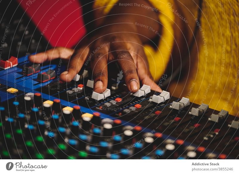 Crop black woman using control panel at radio station mix console broadcast host microphone on air radiocast female ethnic african american audio mixer live