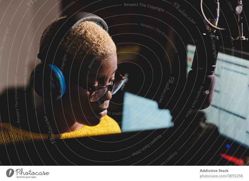 Black woman at radio station broadcast host studio microphone speak cheerful female ethnic black african american dark work job talk professional device live