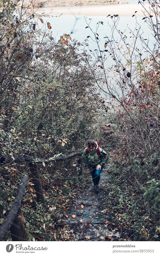 Woman going upstairs on trekking path during trip on autumn outdoors destination hiking holiday vacation hiker explore landscape woman lifestyle female nature