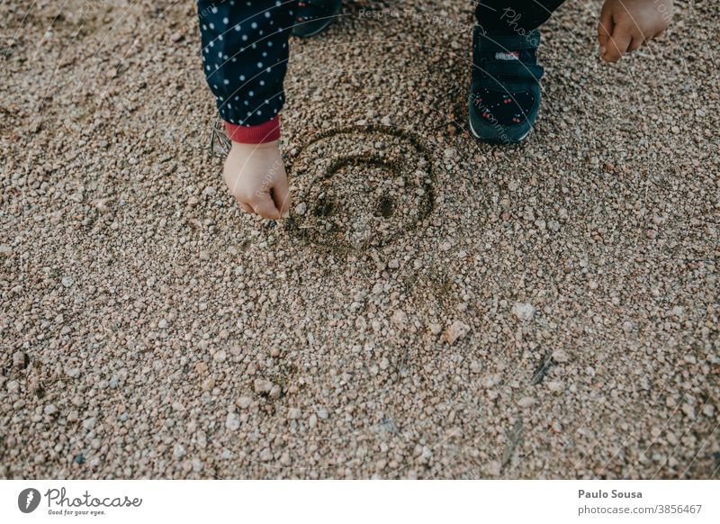Child drawing a smile on sand Smiley childhood Children's game Infancy Joy Exterior shot Childhood memory Playing Colour photo Toddler Happiness Multicoloured