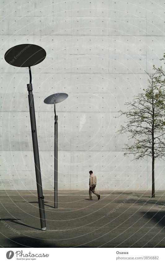 Bowed in front of building Town Architecture Building Facade Wall (barrier) Wall (building) exposed concrete lanterns slanting Man Tree city tree Bleak texture