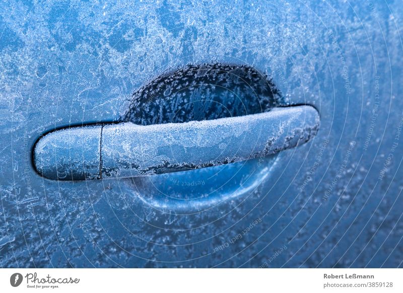 frozen car handle on a blue car Car frost door lock ice crystals unlock temperatures cars locked motor vehicle cool climate winter cold snow icy texture