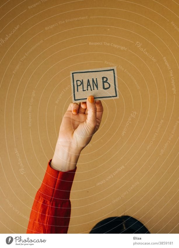 Woman holding a sign with the word plan B written on it Plan B alternative Flexibility planning change Alternative freelance Safety Planning Word authored