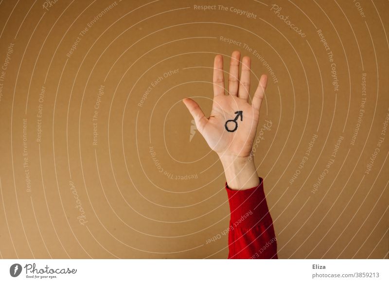 A hand on which the Mars symbol for masculinity is painted against a neutral brown background Hand Man Masculine Gender symbol man up male sex toxic masculinity