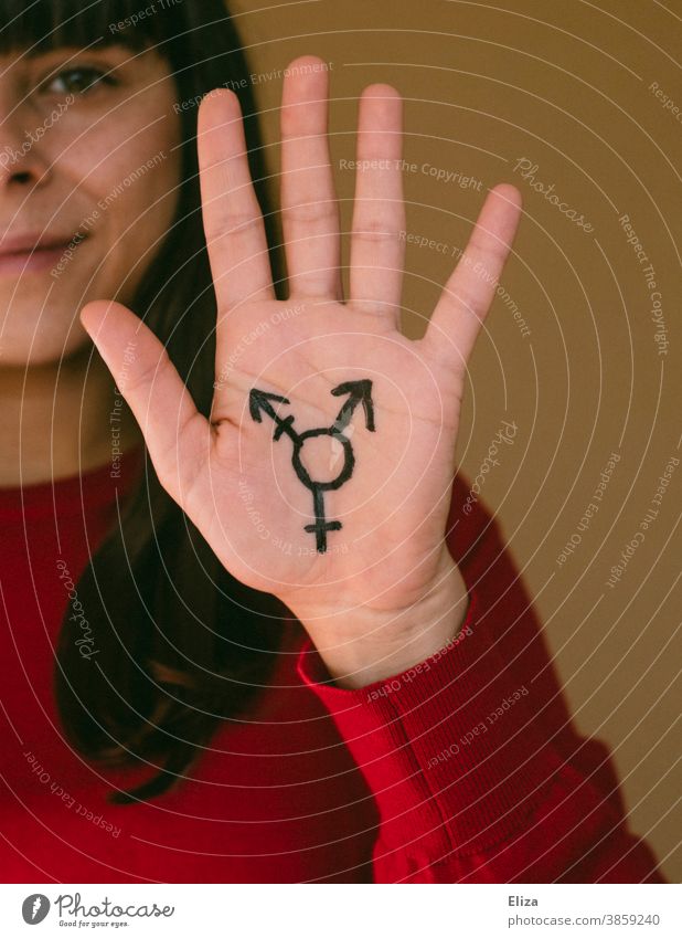 A woman holds up her hand, on which the transgender symbol is painted Transgender equal rights Tolerant Freedom Pride LGBTQ variety Equality Gender