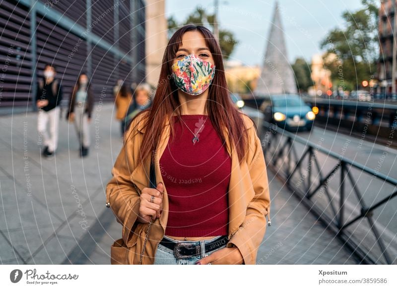 Young caucasian woman using facemask portrait happy people madrid city lifestyle young urban travel beautiful happiness smile spain mobile phone person fashion