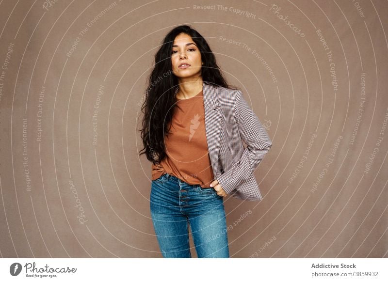 Woman in stylish wear in studio woman style jacket trendy model charming female ethnic young pleasure relax optimist modern enjoy positive casual stand pleasant