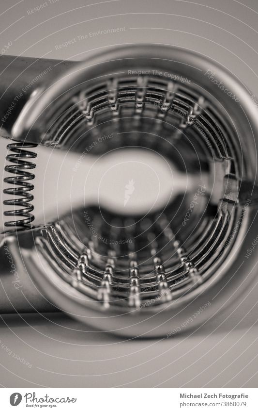 monocrome macro shot of a metal garlic press appliance tool garlic-press old bulb grate equipment eating food stainless home nature lifestyle close-up closeup