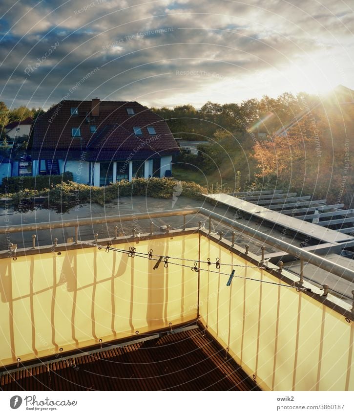 Drying system balustrade Evening cloudy Autumn Shaft of light Deserted Sunset Nature Balcony Warm light Bright Colours Colour photo Exterior shot Environment