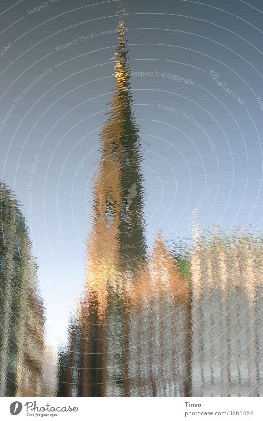 Reflection of a church tower and houses in the water Water Ocean River Lake Town Housefront Warped Distorted surreal Beautiful weather Church spire