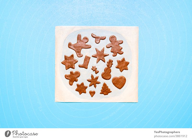 Gingerbread cookies dough cut in different shapes on a blue table. Baking Christmas cookies Christmas baking Merry Christmas above view advent cookies bake