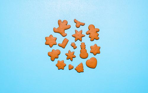 Gingerbread cookies in different shapes on a blue background. Homemade Christmas cookies Christmas baking Merry Christmas above view advent cookies baked