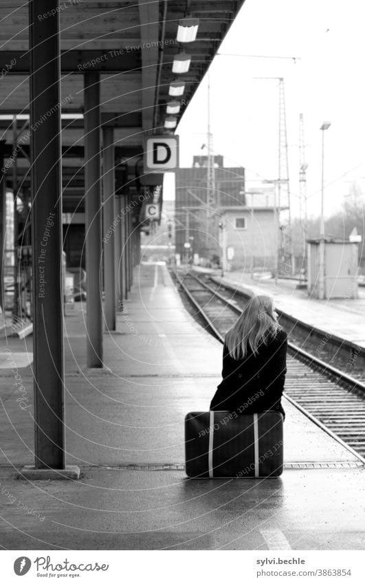 Somehow it will go on ... Railway track Train station Platform Woman Sit Suitcase grappled Wait temporise Depart vacation Wanderlust Homesickness voyage