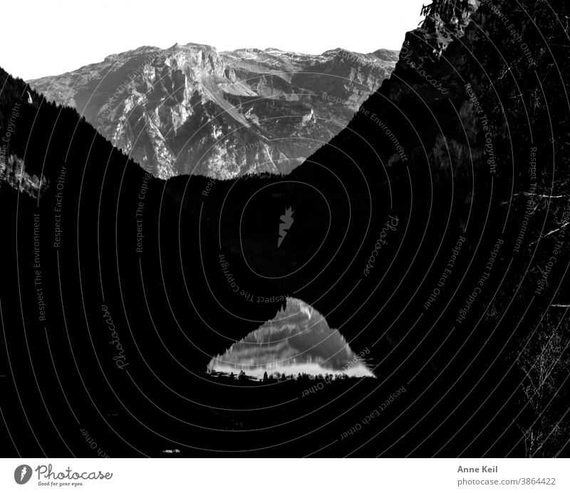 Reflection of the mountain in the mountain lake in light and shadow. - a  Royalty Free Stock Photo from Photocase