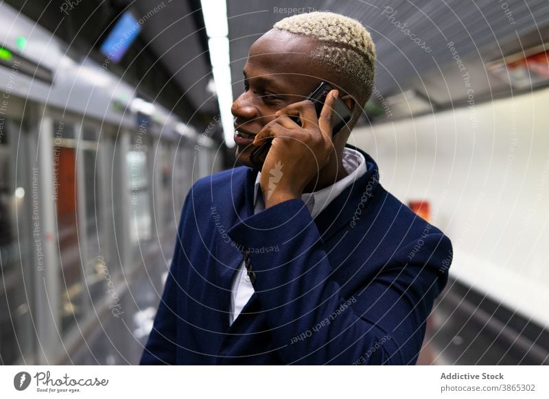 Black businessman talking on smartphone in subway commute work underground entrepreneur speak using male ethnic black african american formal device station