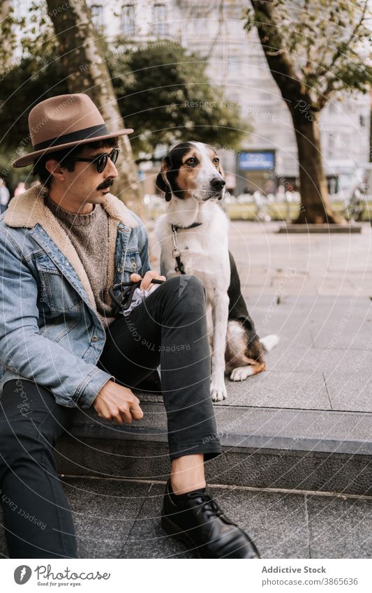 Stylish man with dog in city style trendy treeing walker coonhound obedient street relax domestic male pet stroll town animal canine friend loyal modern