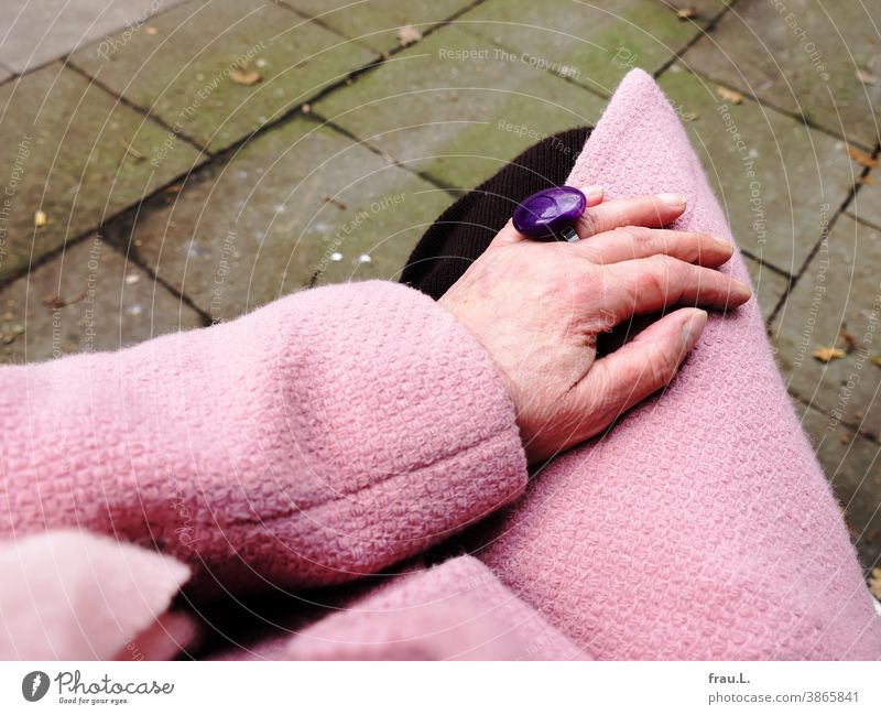 Old woman's hand with pink coat, pink scarf and purple ring and small hangover scratch Hand Human being Knitted skirt Fashion Finger Ring Costume jewelry