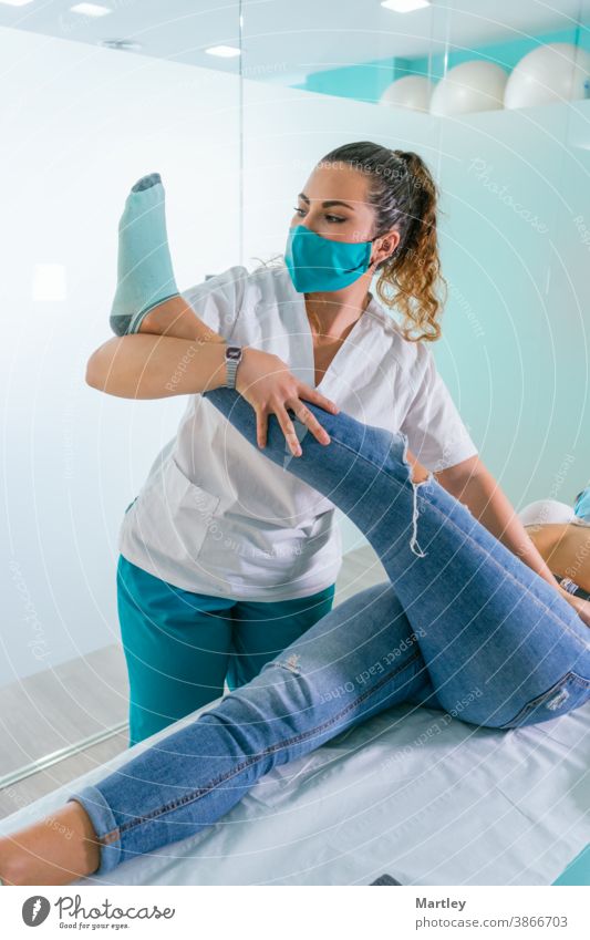 Female therapist stretching leg of patient during physiotherapy session in contemporary clinic physiotherapist rehabilitation massage woman touch medicine cure