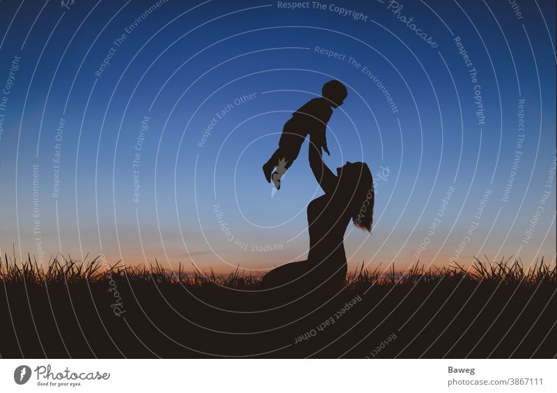 Silhouette of mother and son at sunset silhouettes time-out Tree Sunrise Sunset Family Woman Mother Son Child relation Matrimony relaxation free time Joy Peace
