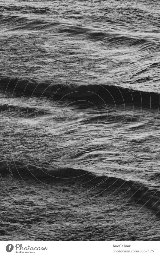 Close up of some waves in the middle of the ocean in black and white with copy space stormy spray monochrome concepts exploration horizontal photograph