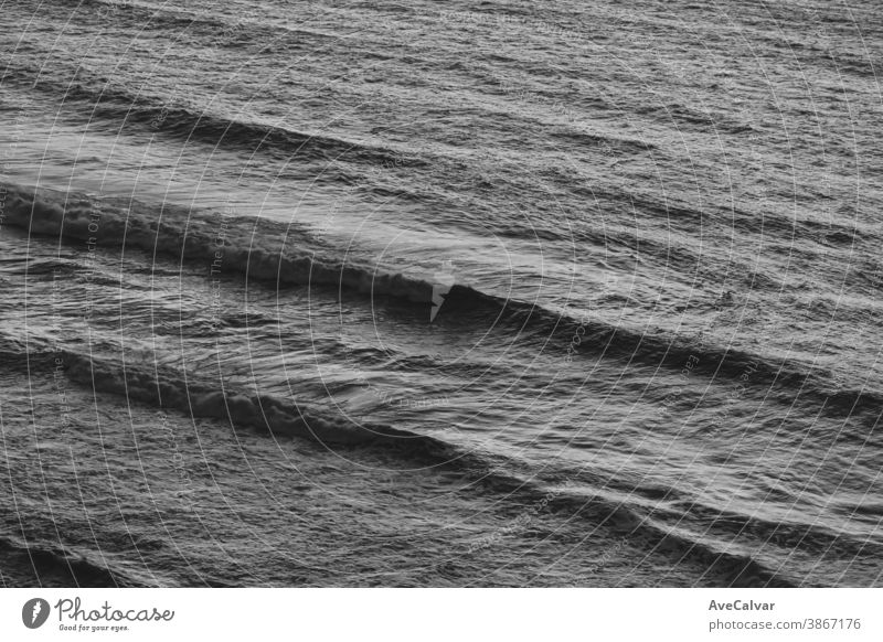 A close up of some waves in the middle of the ocean in black and white with copy space stormy spray monochrome concepts exploration horizontal photograph