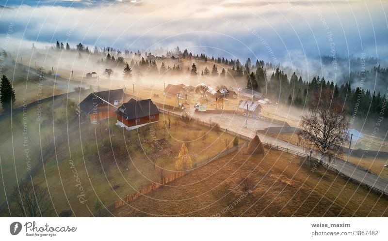 Alpine village. Autumn rural landscape. Cold November morning. Morning fog in mountain valley. nature autumn tree forest travel outdoor season background fall