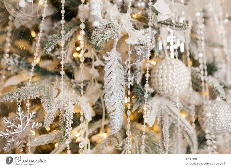 Christmas tree decoration: Christmas glass toys, flickering garlands. concept: an example of the interior of a living room of a residential building. image for greeting card or poster