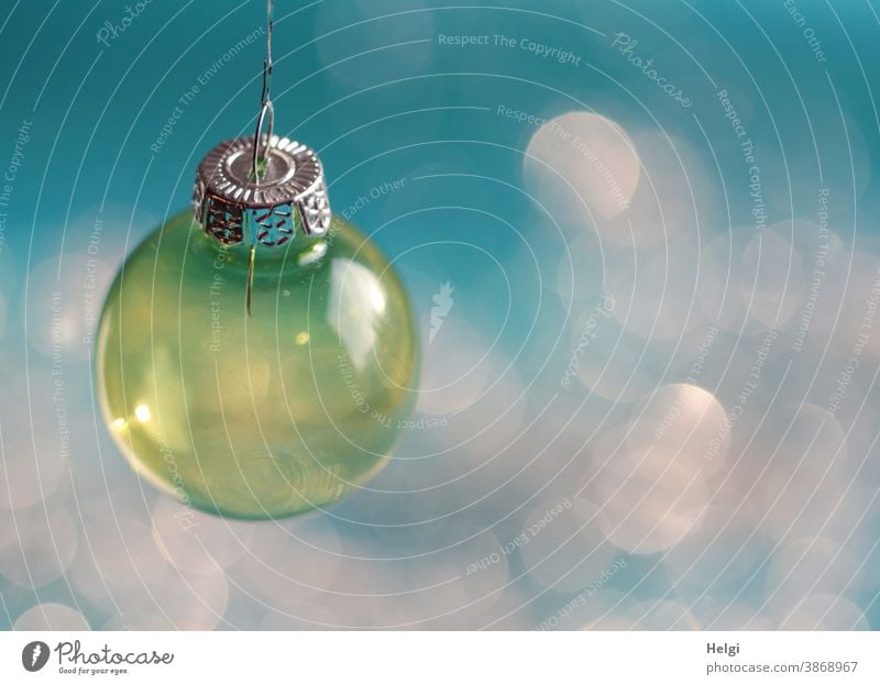 yellow glass christmas tree ball hangs in front of a turquoise background with Bokeh Sphere Glass ball Glitter Ball Christmas Christmas tree ball Decoration