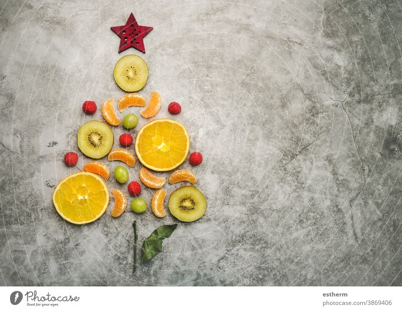 Christmas concept background. Pieces of fruit in the form of a christmas tree fruits orange healthy food diet christmas dessert kiwi slice fresh tangerine