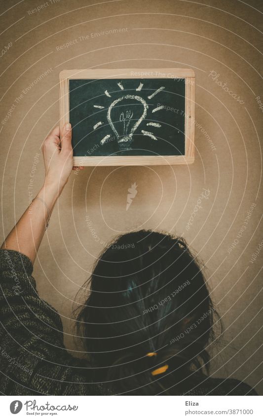 A light bulb painted on a blackboard. Concept a woman has an idea. Idea Creativity Electric bulb solution Inspiration concept have an idea Think innovation