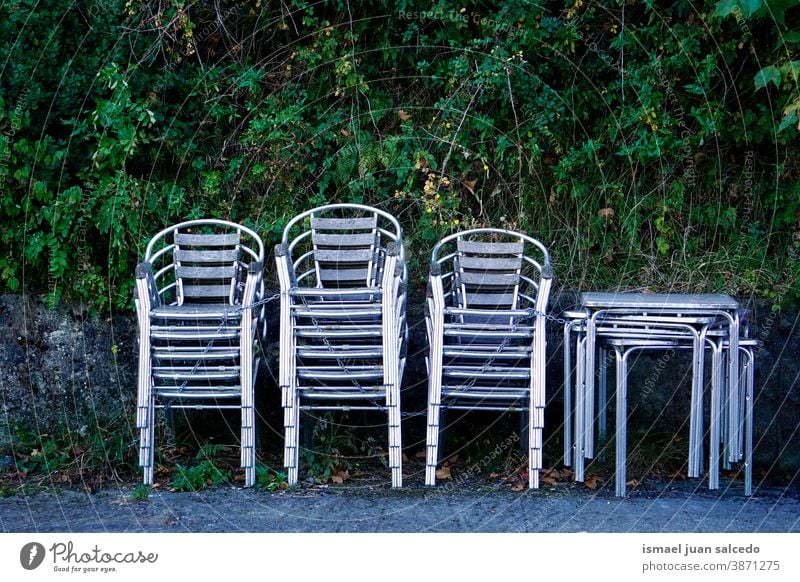 metallic chairs on the street streetphotography Seating seat Empty Row of chairs Seating capacity Places Sit Colour photo Furniture tables