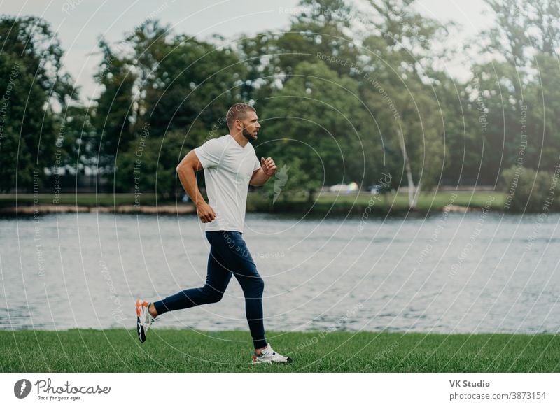 Sporty man jogging in a park stock photo