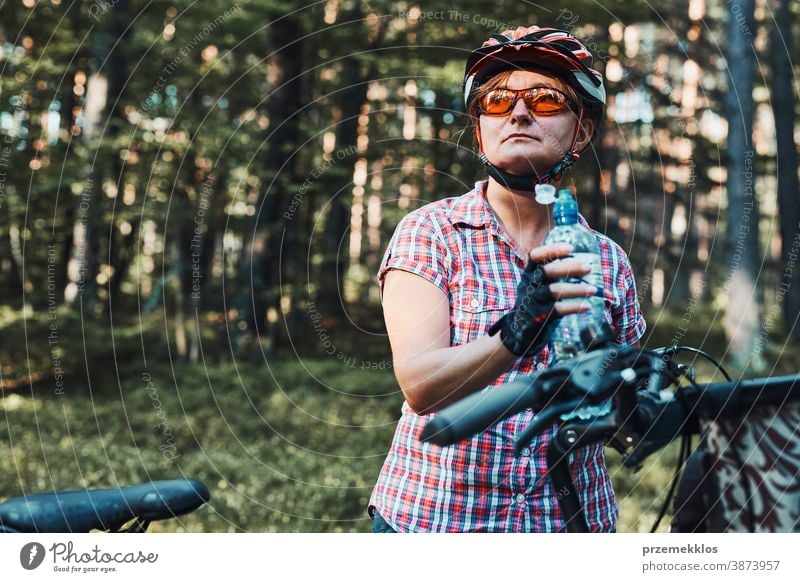 Active woman spending vacation summer time on a bicycle trip in a forest joy freedom fall recreation adventure enjoy forest landscape forest trees forest path
