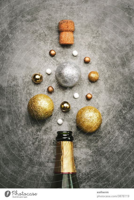 New Years Eve celebration concept background.Champagne bottle with Christmas balls christmas new Years Eve copy space bubble new Years Eve concept explosion