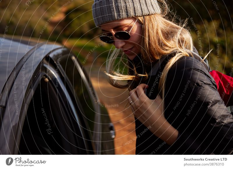 Young Woman With Backpack Getting Out Of Car Before Setting Off For Hike In Countryside hike hiking woman young women walk walking trek active backpack holiday