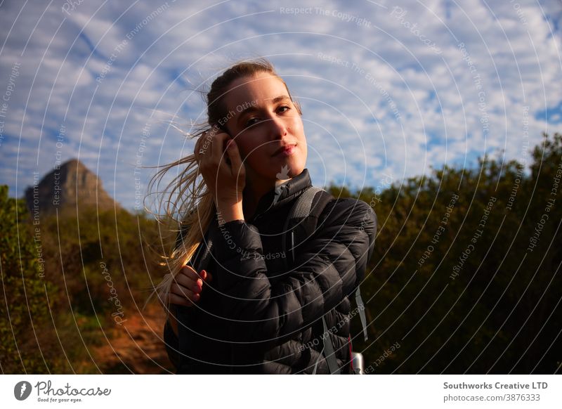 Portrait Of Young Woman With Backpack Hiking Along Path Through Countryside wanderlust walking woman young women hike hiking trek active backpack holiday