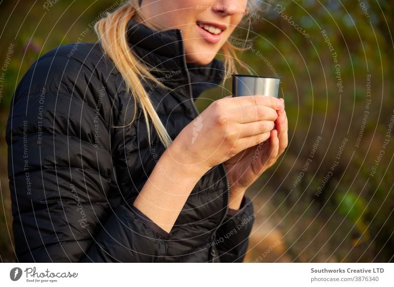 Close Up Of Woman Taking A Break From Countryside Hike And Drinking Coffee  From Flask - a Royalty Free Stock Photo from Photocase