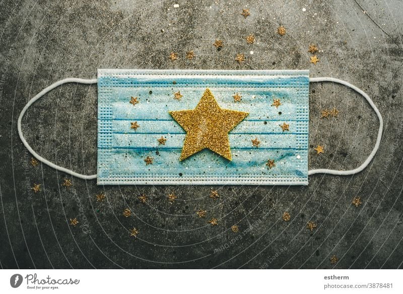 Christmas concept background.Protective surgical mask with christmas star coronavirus covid covid-19 christmas tree christmas background xmas christmas gifts