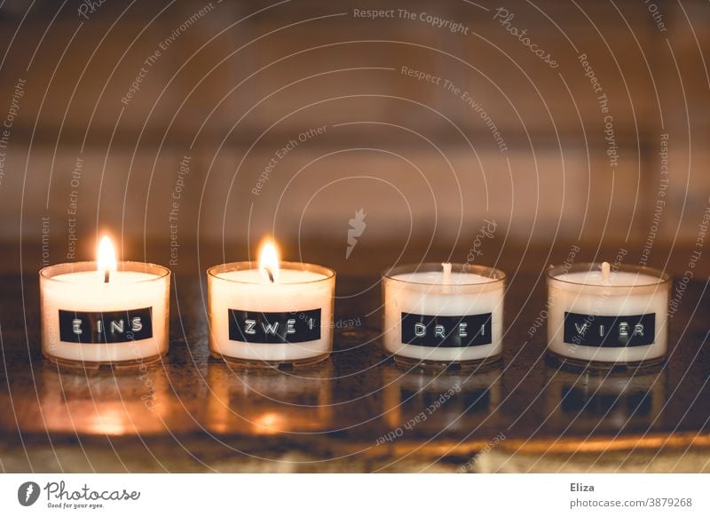 Two candles are burning on a minimalist Advent wreath, consisting of numbered tea lights Christmas wreath two 2nd Advent Second Advent Tea lights Burn