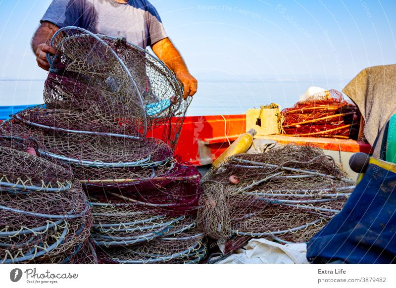 Fisher pile up fishing net on the beach Along Angling Arrange Ashore Beach Boat Bunch Catch Check Coast Coastline Drag Dry Docked Effort Empty Entrap Equipment