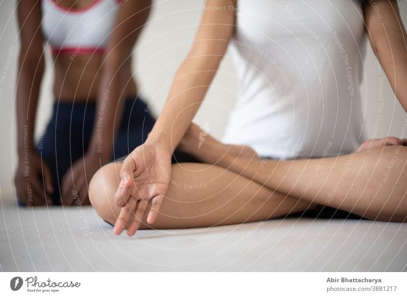 Indian black and white brunettes girls performing yoga/sports /exercise in  underwear in front of a white background. Indian lifestyle - a Royalty Free  Stock Photo from Photocase