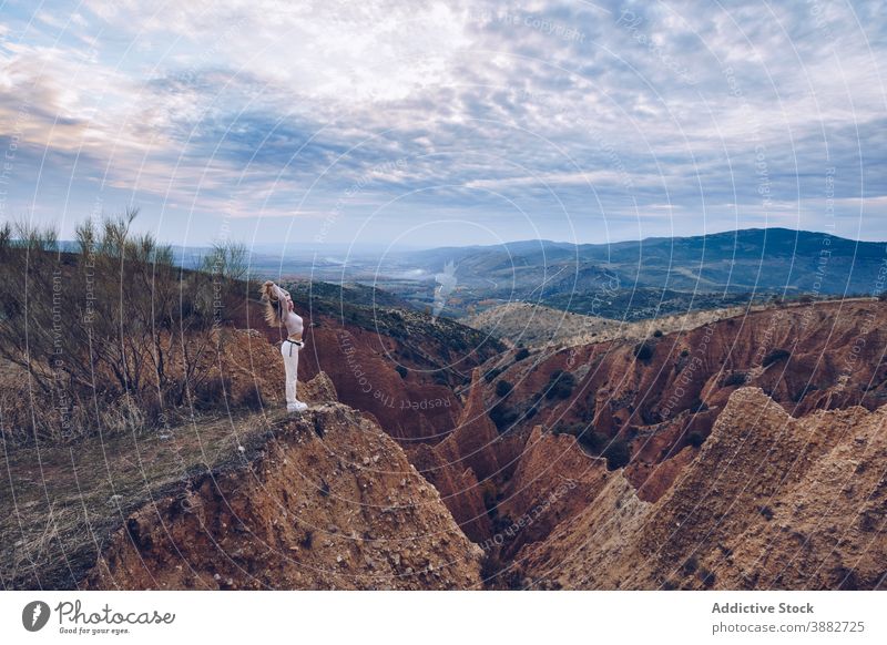 Travelling woman observing rocky mountains travel explore observe contemplate wild nature sandstone explorer alone adventure journey tourism wanderlust highland