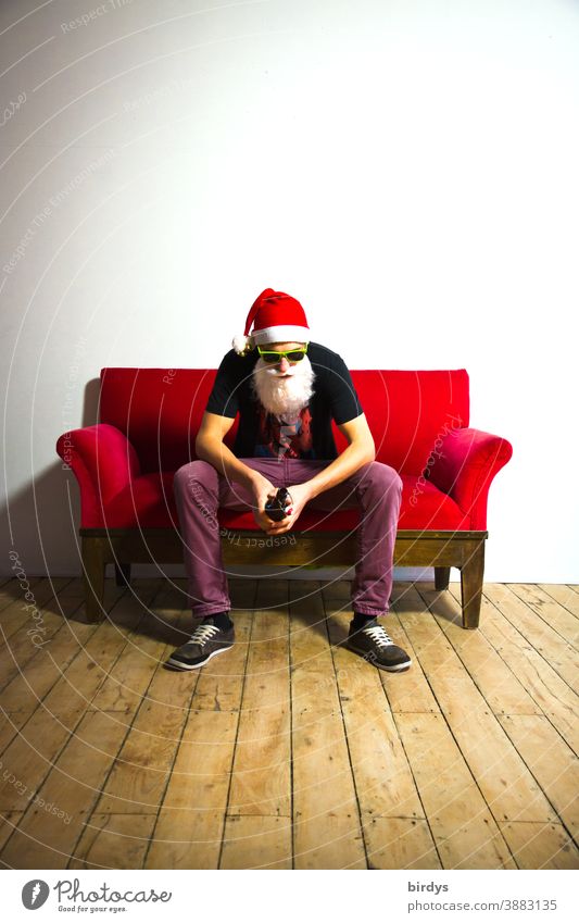 frustrated santa claus with beer bottle on a red sofa Santa Claus Santa Claus hat Santa's cap Christmas Christmas & Advent Bottle of beer Corona measures
