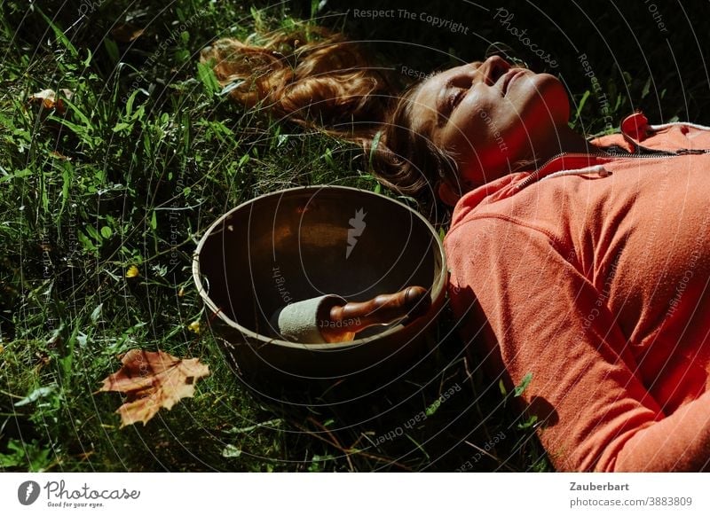 Beautiful woman with singing bowl and autumn leaves in the grass Woman pretty Grass Leaf Autumn Sun Meditation Wellness relaxation Sound Bowl Contentment Calm