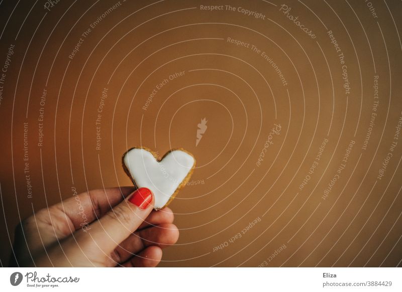 Female hand holding a heart-shaped cookie with white icing for Valentine's Day or Mother's Day Cookie Heart Heart-shaped Love Delicious cute nibble Candy